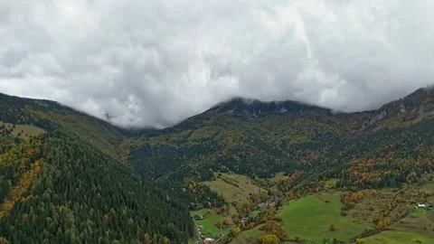 Hyperlapse aerial of mountain valley with moving clouds and colorful autumn Stock-Footage 321074671