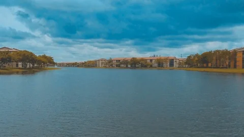 Hyperlapse aerial shot over lake surrounded by buildings Stock Footage 89919892