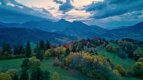 Hyperlapse aerial view of autumn forest and mountain landscape at dusk with Stock Footage 321014397