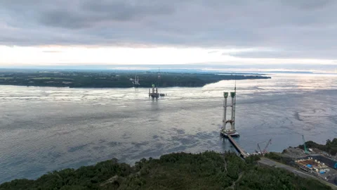 Hyperlapse Aerial View of Chacao Bridge Construction and Channel Under Cloudy Stock Footage 345009528
