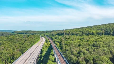 Hyperlapse aerial view of highway road and train bridge Stock-Footage 280827339