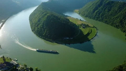 Hyperlapse aerial view of a river cruise ship on the Danube loop at sunset Stock Footage 340824765