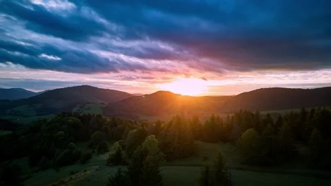 Hyperlapse aerial view of vibrant sunset sky over mountain forest , carpathians 動画素材 318137696