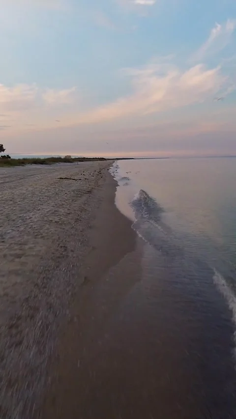 Hyperlapse along the sea edge in the early morning hours. Vertical Video Stock Footage 276164683
