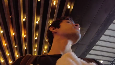 Hyperlapse and shot from below of the face of a hipster hispanic man walking 動画素材 240228960