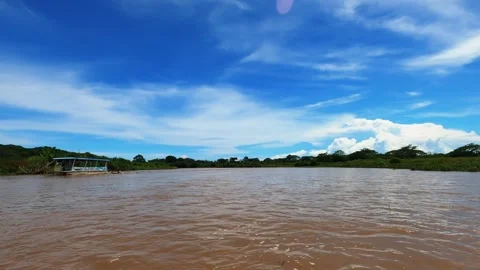 Hyperlapse from a boat tour on the Tarcoles River, gliding through lush Stock Footage 285530337