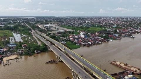 Hyperlapse Bridge spanning a wide river is bustling with vehicular activity Stock Footage 336473484