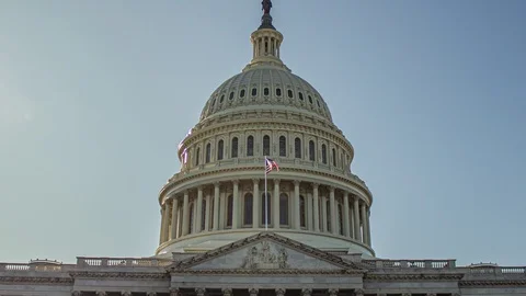 Hyperlapse of the Capitol in Washington DC, with the american flag waving. 119239508