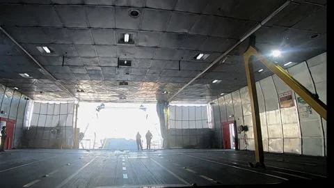 Hyperlapse cars leaving platform of the hold of the passenger ship opening Stock Footage 169874883