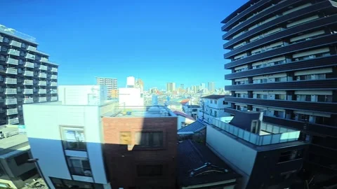 A hyperlapse of cityscape by side view of a moving urban monorail in Tokyo Stock Footage 331791395