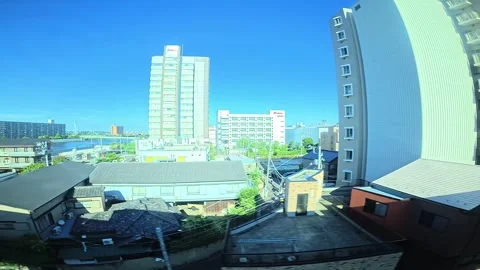 A hyperlapse of cityscape by side view of a moving urban monorail in Tokyo Stock Footage 331791397