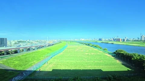 A hyperlapse of cityscape by side view of a moving urban monorail in Tokyo Stock Footage 331791401