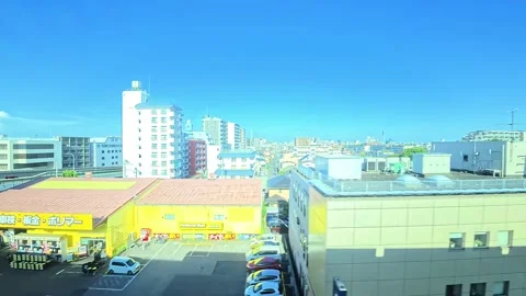 A hyperlapse of cityscape by side view of a moving urban monorail in Tokyo Stock Footage 331791410
