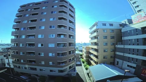A hyperlapse of cityscape by side view of a moving urban monorail in Tokyo Stock Footage 331791434