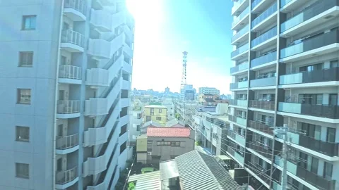 A hyperlapse of cityscape by side view of a moving urban monorail in Tokyo Stock Footage 331791448