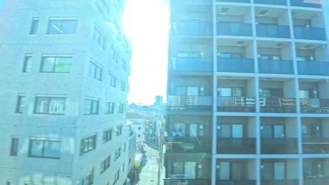 A hyperlapse of cityscape by side view of a moving urban monorail in Tokyo Stock Footage 331791451