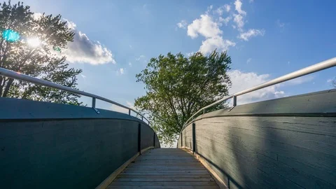 Hyperlapse of Clouds Moving over a Footbridge In Wisconsin Stock Footage 98846301