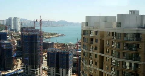 Hyperlapse of constructing buildings, 12 hours. Cranes working next to the sea Stock Footage 103309309