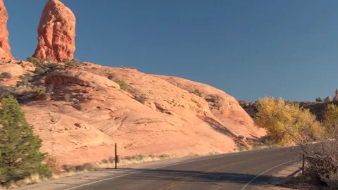 HYPERLAPSE: Driving along the empty road through Arches National Park at sunset Stock Footage 76992217