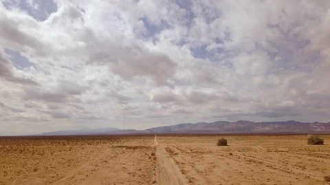 Hyperlapse, driving through the Mojave Desert as clouds drift across the sky Stock Footage 92559361