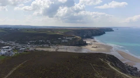 Hyperlapse drone Porthtowan Beach  sun rays over cliffs and turquoise water Stock Footage 160572181