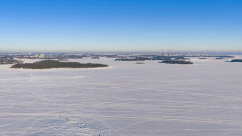 Hyperlapse drone shot of people walking on ice in the archipelago of Helsinki Stock Footage 331403869