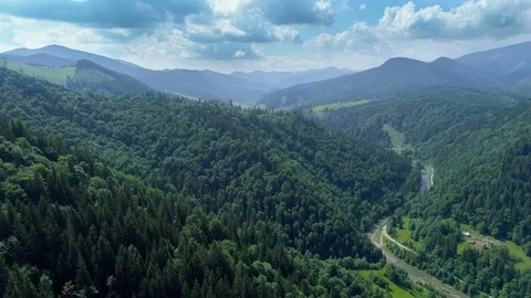 Hyperlapse flight over high mountains with a river snaking across countryside Stock Footage 94744199