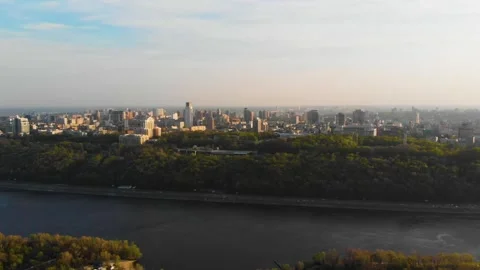 Hyperlapse flight over riverside park toward Kyiv skyline Stock Footage 331889304