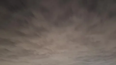 A hyperlapse footage of clouds moving at dusk 動画素材 259579591