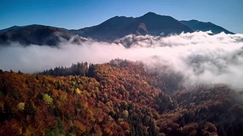Hyperlapse forward flight over colorful autumn mountains with rolling fog under Stock-Footage 322684432