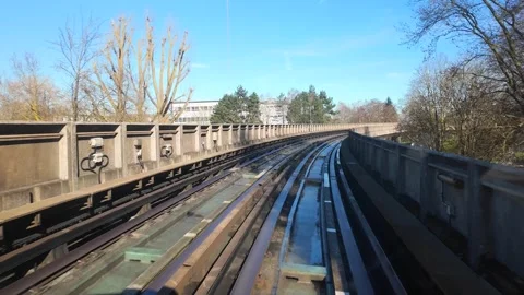 Hyperlapse of metro train speeding on elevated urban track in modern cityscape Video stock 329680443