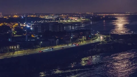 Hyperlapse moonlight reflecting on waterfront at night in Lisbon, Portugal Stock Footage 282363409