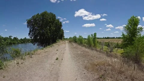 Hyperlapse moving forward along a dirt levee path Vídeo Stock 337856509