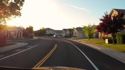 HYPERLAPSE, POV: Driving through the scenic streets of luxury suburbs at sunrise Stock Footage 97077245