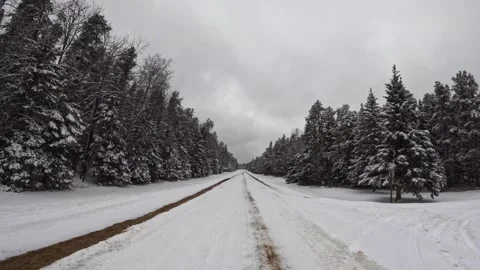 Hyperlapse POV from the front of a vehicle moving along a snow covered road  Stock Footage 263278195