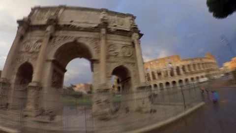 Hyperlapse Rome, Arch of Constantine and Colosseum rainy day at sunset, orbit Video stock 106556751