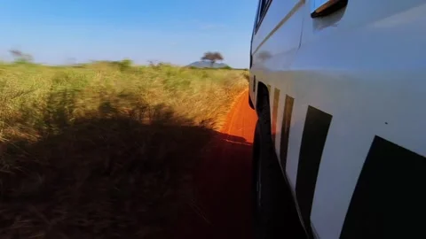 A hyperlapse shot from the side of the Jeep as it moves through Tsavo National Stock Footage 305015949