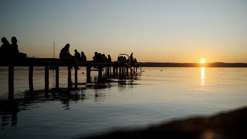 Hyperlapse shot of sunset with people at beautiful lake Stock Footage