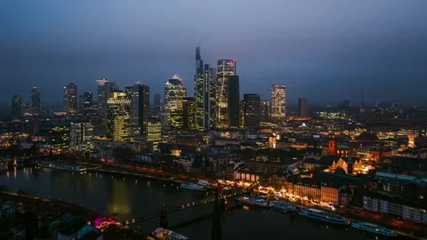 Hyperlapse showing transition from day to night over illuminated Frankfurt skyli Stock Footage 331942110