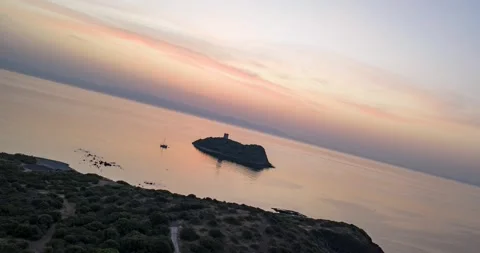 Hyperlapse of sunset over coastal tower in Pula, Italy. Aerial backward, copy Stock Footage 334094322