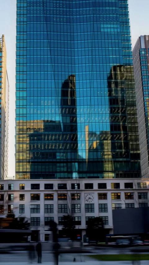 Hyperlapse of Tokyo Station Marunouchi skyscraper reflections in vertical video Stock Footage 341616281