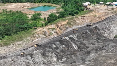 A hyperlapse video showing a truck dumping soil for a coal mine haul road Video stock 343248737