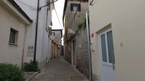 Hyperlapse walk on narrow old historic streets past old stone houses in Slovenia Stock Footage 154494696