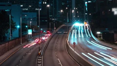 Hyperlapse with zoom out of red and white car light trails flowing along a Stock Footage 347869268