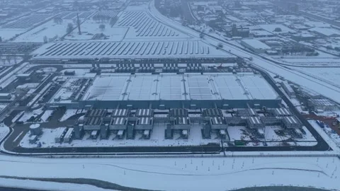 Hyperscale data center campus with adjacent solar panels covered in snow Stock Footage 328840052