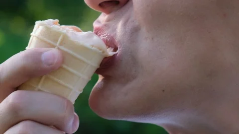 Hypersensitivity of teeth. Man eats ice cream and is in pain Stock Footage 114453604