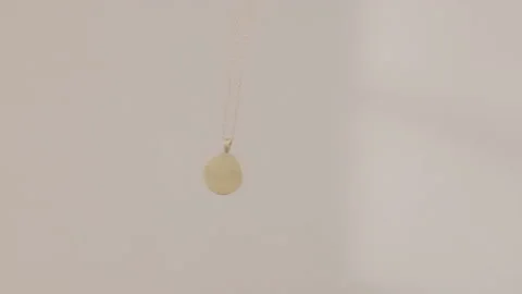 Hypnosis session pendant on chain sways on light background Stock Footage 237745095