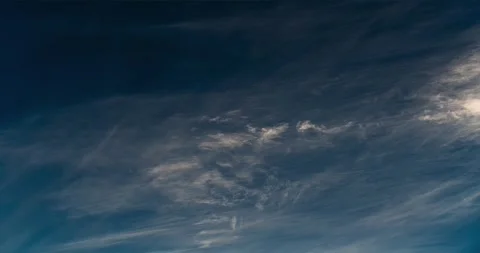 Hypnotic altocumulus and cirrus clouds warm the sky as the sun sets. Stock Footage 301453343