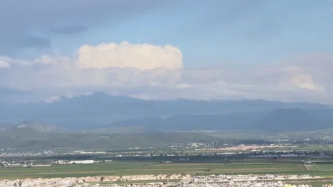 A hypnotic Interplay between clouds with a volcano Stock Footage 314345741