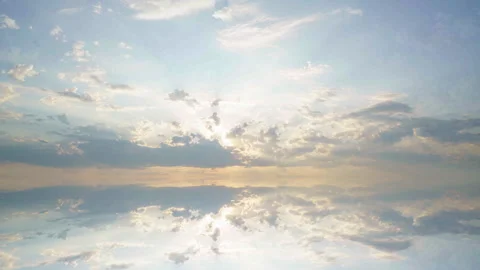 Hypnotic mirrored cloudscape with flowing clouds and radiant sunlight... Stock Footage 342732151